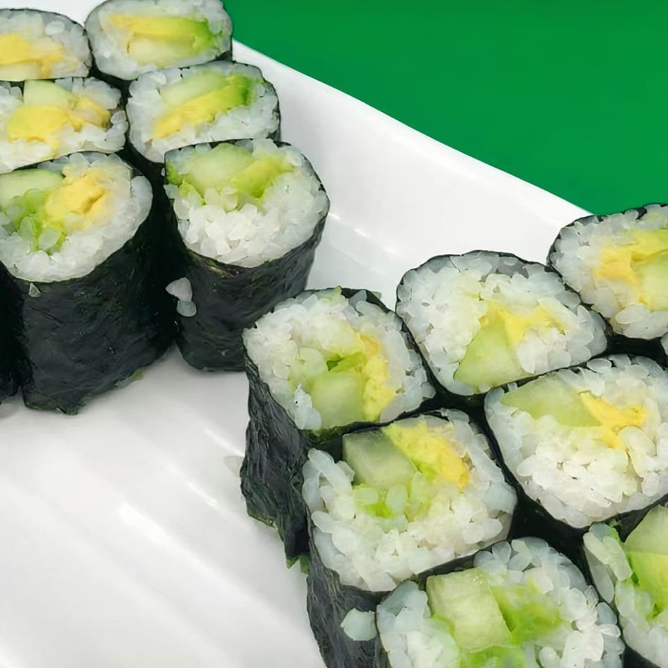 Platter of Kawaii Sushi rolls with avocado and egg, presented on a white plate.